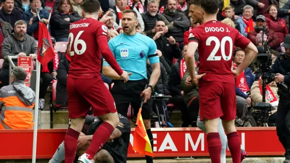 Assistant referee Constantine Hatzidakis returns to duty after Andy Robertson clash