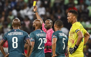 Referee Olani Kwinda issues a yellow card during AmaZulu vs Orlando Pirates match