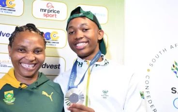 Bayanda Walaza and his mother during the welcoming of Tatjana Smith and part of the Athletics Relay Team by Minister Gayton Mckenzie and SASCOC at O.R Tambo International Airport on August 13