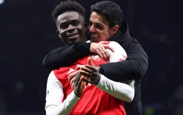 Bukayo Saka of Arsenal hugged by Mikel Arteta manager of Arsenal
