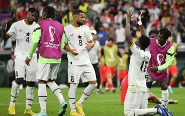 Daniel Amartey of Ghana prays while Ghana players celebrate their 3-2 victory