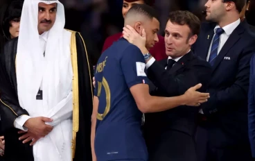 Kylian Mbappe of France is consoled by President of France Emmanuel Macron