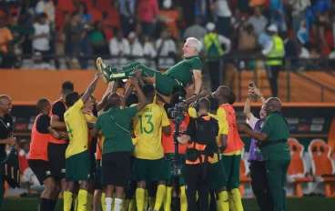 South African players celebrates with Hugo Henri Broos (Head Coach) of South Africa after winning the penalty shoot out of the TotalEnergies CAF Africa Cup of Nations, 3rd Place Playoff match
