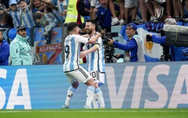 Julian Alvarez of Argentina celebrates with Lionel Messi of Argentina