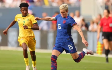Megan Rapinoe #15 of the United States kicks the ball under pressure from Lebogang Ramalepe #2 of South Africa during the first half at Soldier Field on September 24, 2023 in Chicago, Illinoi