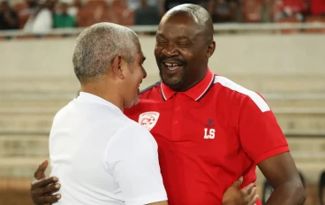 Sekhukhune United coach Lehlohonolo Seema hugs Magesi FC coach Clinton Larsen