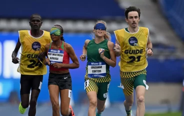 Mary Waithera Njoroge and her guide James Boit (l) of Kenya compete against Louzanne Coetzee and her guide Erasmus Badenhorst of South Africa in the Women's 1500m T11 race during day two of t