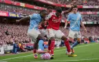 manchester-city-s-jeremy-doku-and-arsenal-s-noni-madueke-fight-for-the-ball-21-september-202516.webp