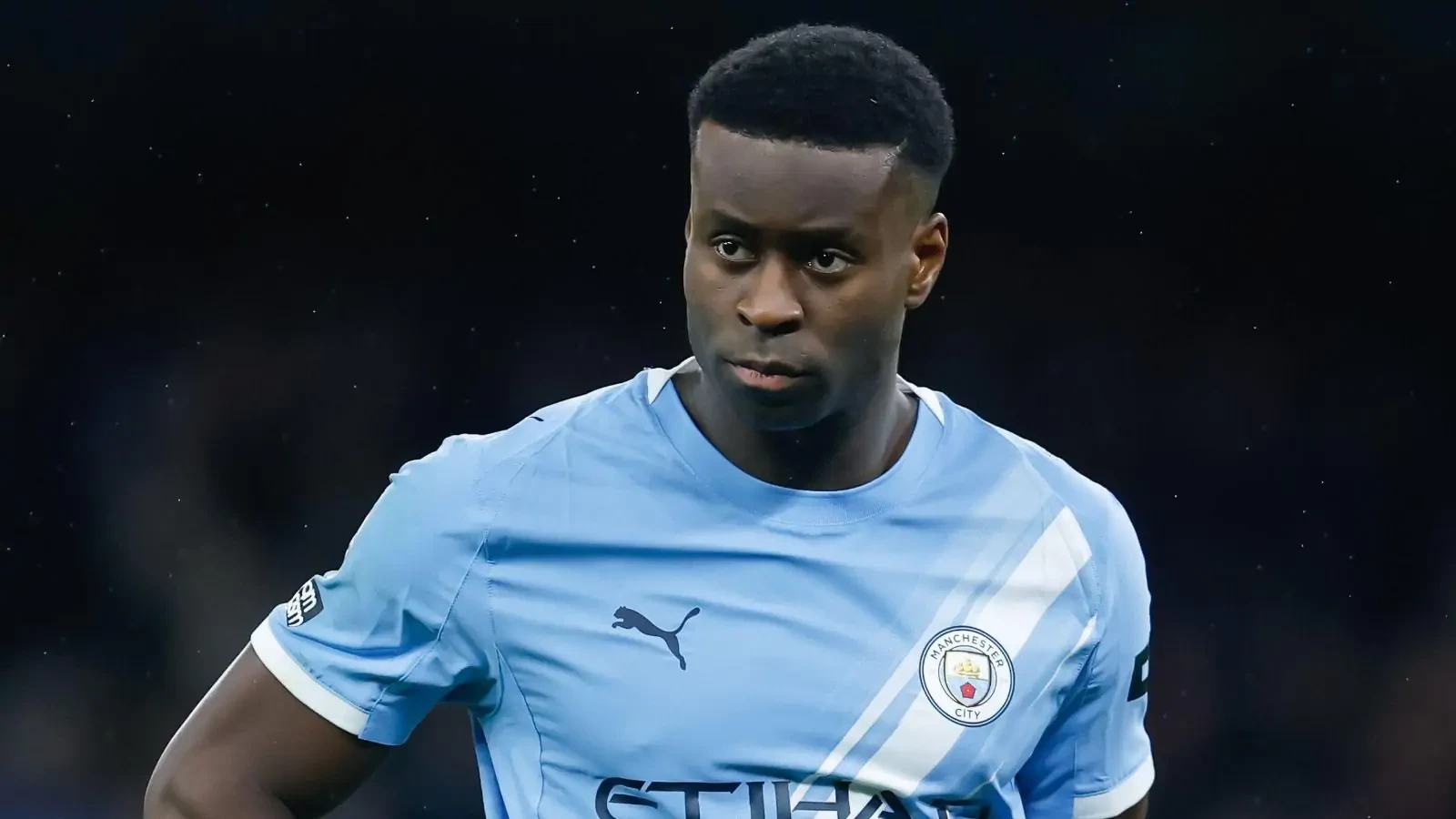 Marc Guehi in a Manchester City home shirt