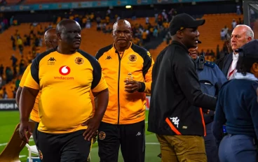 Former Kaizer Chiefs coach Molefi Ntseki escorted by police after fans throwing objects on him during the Carling Knockout match between Kaizer Chiefs and AmaZulu FC at FNB Stadium on October