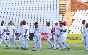 Moroka Swallows players do a pitch inspection