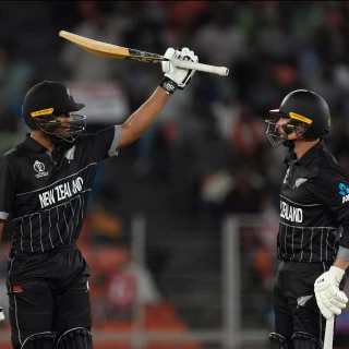 New Zealand's Rachin Ravindra, left, celebrates his fifty runs