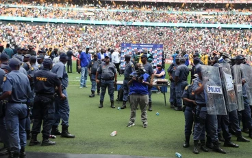 Police baracade protects the coaches after Soweto Derby at FNB Stadium