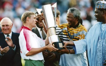 President Nelson Mandela and Issa Hayatou and CAF President congratulating captain Neil Trovey at the 1996 AFCON finals