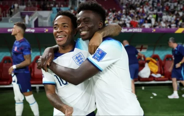 England forward Raheem Sterling celebrates with teammate Bukayo Saka