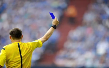 Referee shows a blue card