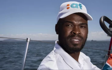 Sibusiso Sizatu, skipper of the ArchAngel yacht, sails with his crew offshore Cape Town on November 13, 2022. (Photo by RODGER BOSCH / AFP)