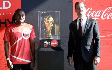 Siphiwe Tshabalala alongside the FIFA World Cup trophy during the Coca Cola global tour