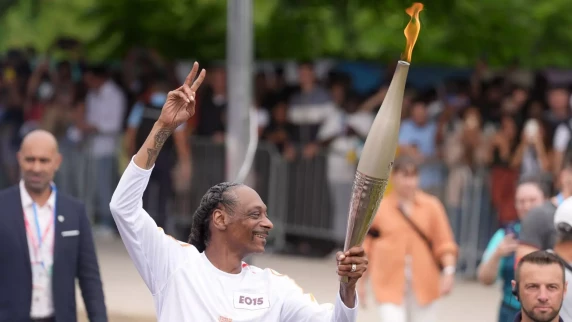 Olympic torch bearer Snoop Dogg carries flame of different kind through Paris