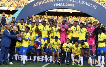 CAF President Patrice Motsepe and FIFA President Gianni Infantino hand the trophy to Mamelodi Sundowns captain Themba Zwane during the African Football League, Final - 2nd Leg match between M