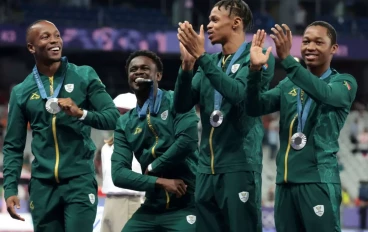 Silver medalists Bayanda Walaza, Shaun Maswanganyi, Bradley Nkoana and Akani Simbine of Team South Africa celebrate on the podium during the Men's 4 x 100m medal ceremony on day fourteen of t