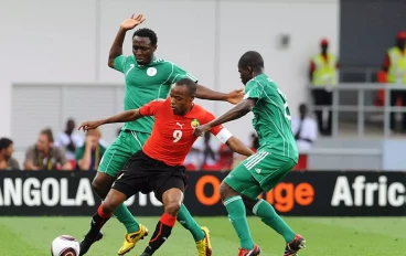Chinedu Obasi and Obinna Nsofor of Nigeria tackle Tico-Tico Bucuane of Mozambique during the African Nations Cup Group C match between Nigeria and Mozambique, at the Alto da Chela Stadium on