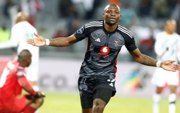 Tshegofatso Mabasa of Orlando Pirates scores his goal against Sifiso Mlungwana of Golden Arrows during the DStv Premiership match between Orlando Pirates and Golden Arrows at Orlando Stadium