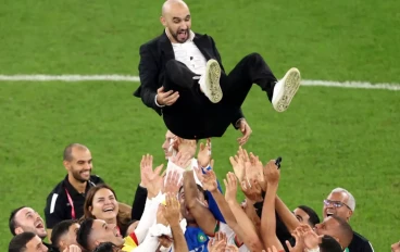 Walid Regragui, Head Coach of Morocco, celebrates with the team after their qualification to the knockout stages during the FIFA World Cup Qatar 2022